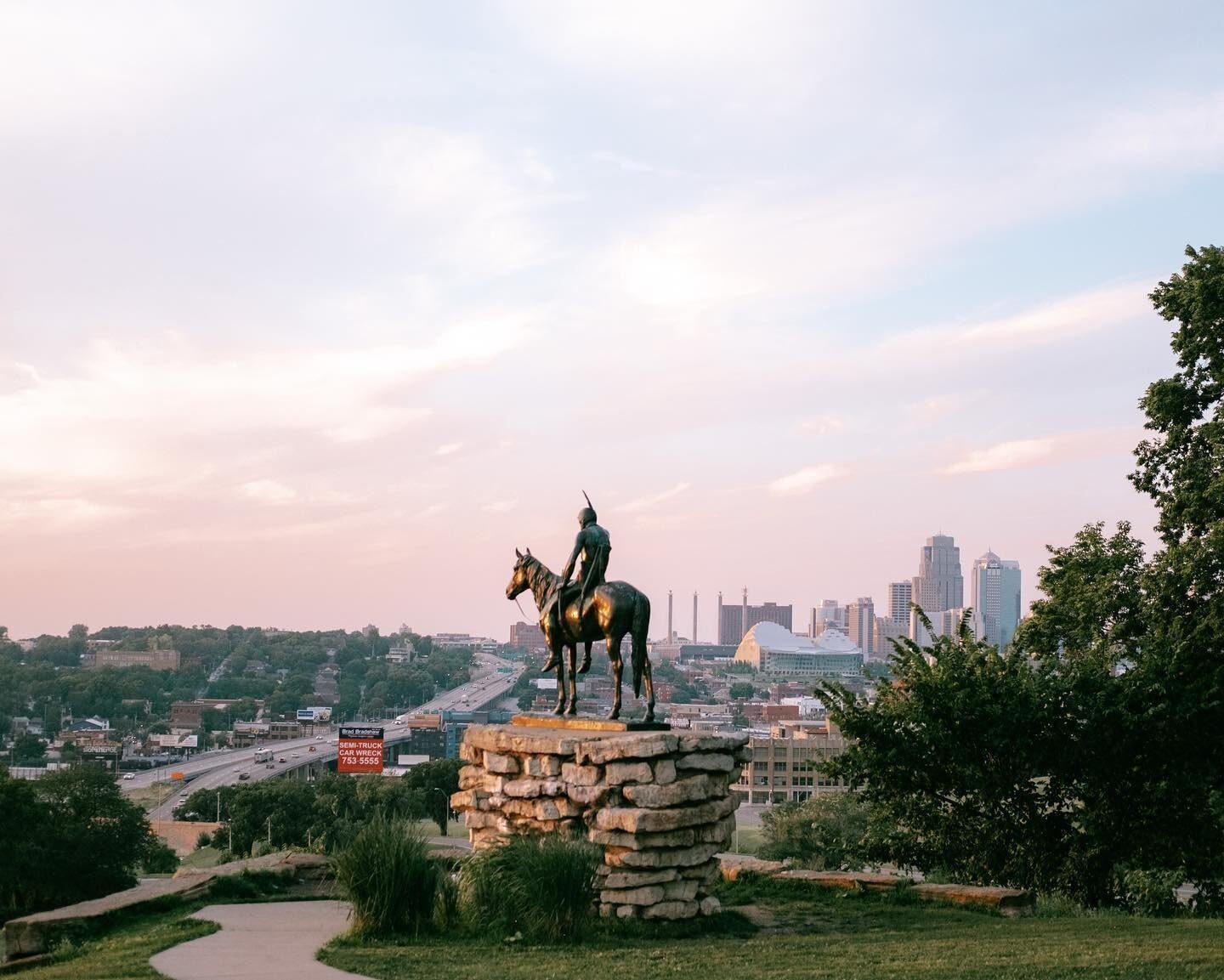 The Scout statue on horseback overlooking the Kansas City skyline at dusk